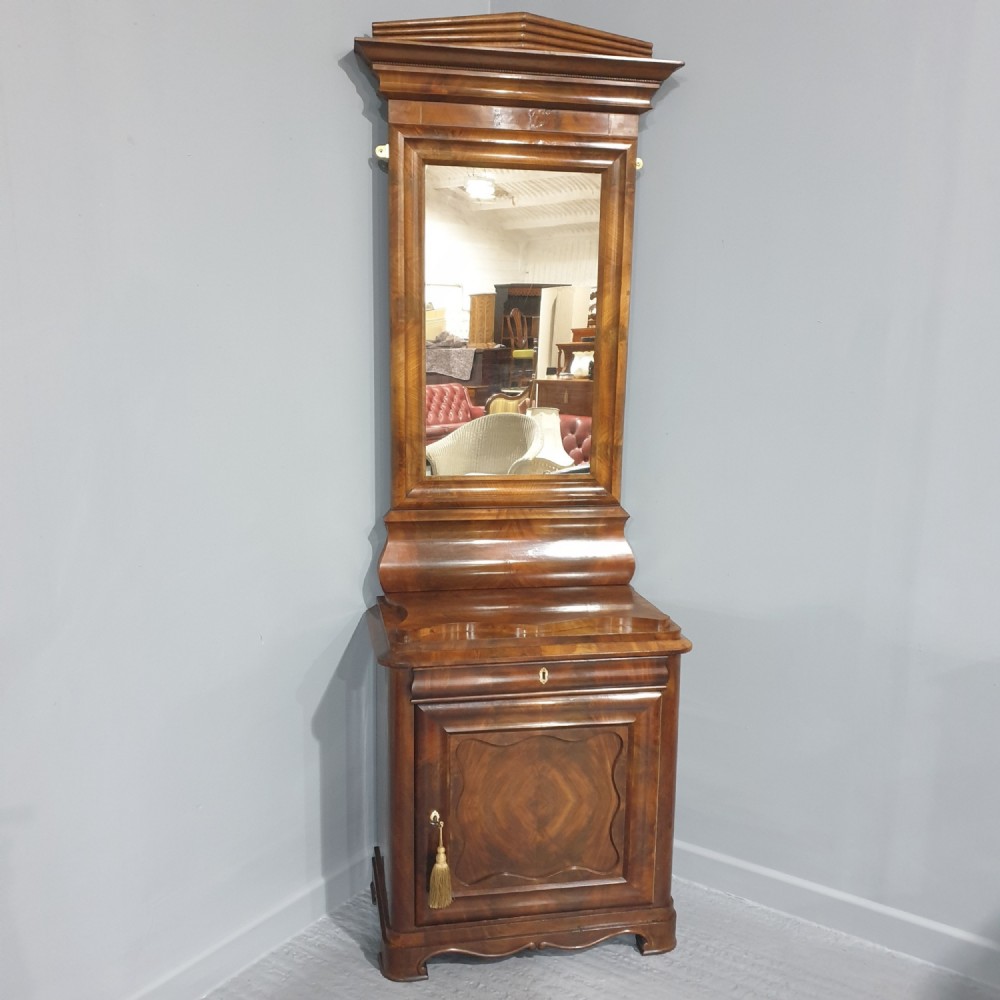 An antique Biedermeier tall warm brown veneered console cabinet featuring a fitted rectangular mirror above a single drawer and panelled cupboard base.