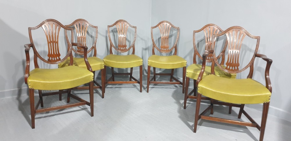 A set of six Georgian mahogany shield-back dining chairs, including two carvers and four side chairs, featuring yellow-green leather seats with brass studding. View III