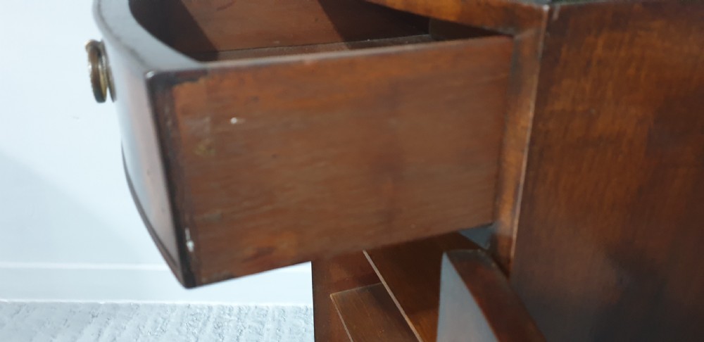 A tall, narrow mahogany cabinet featuring three open graduated shelves above a single drawer and a lower cupboard door with an oval flame mahogany inlay. View XIII