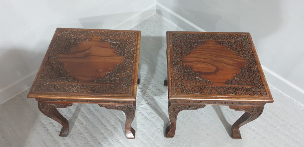 A pair of carved dark padouk wood low tables supporting large Cantonese famille rose porcelain temple jars topped with sculpted lion finials. View IV