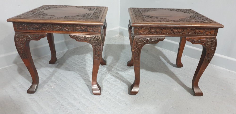 A pair of carved dark padouk wood low tables supporting large Cantonese famille rose porcelain temple jars topped with sculpted lion finials. View VII