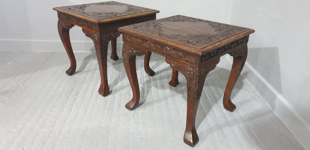A pair of carved dark padouk wood low tables supporting large Cantonese famille rose porcelain temple jars topped with sculpted lion finials. View VIII