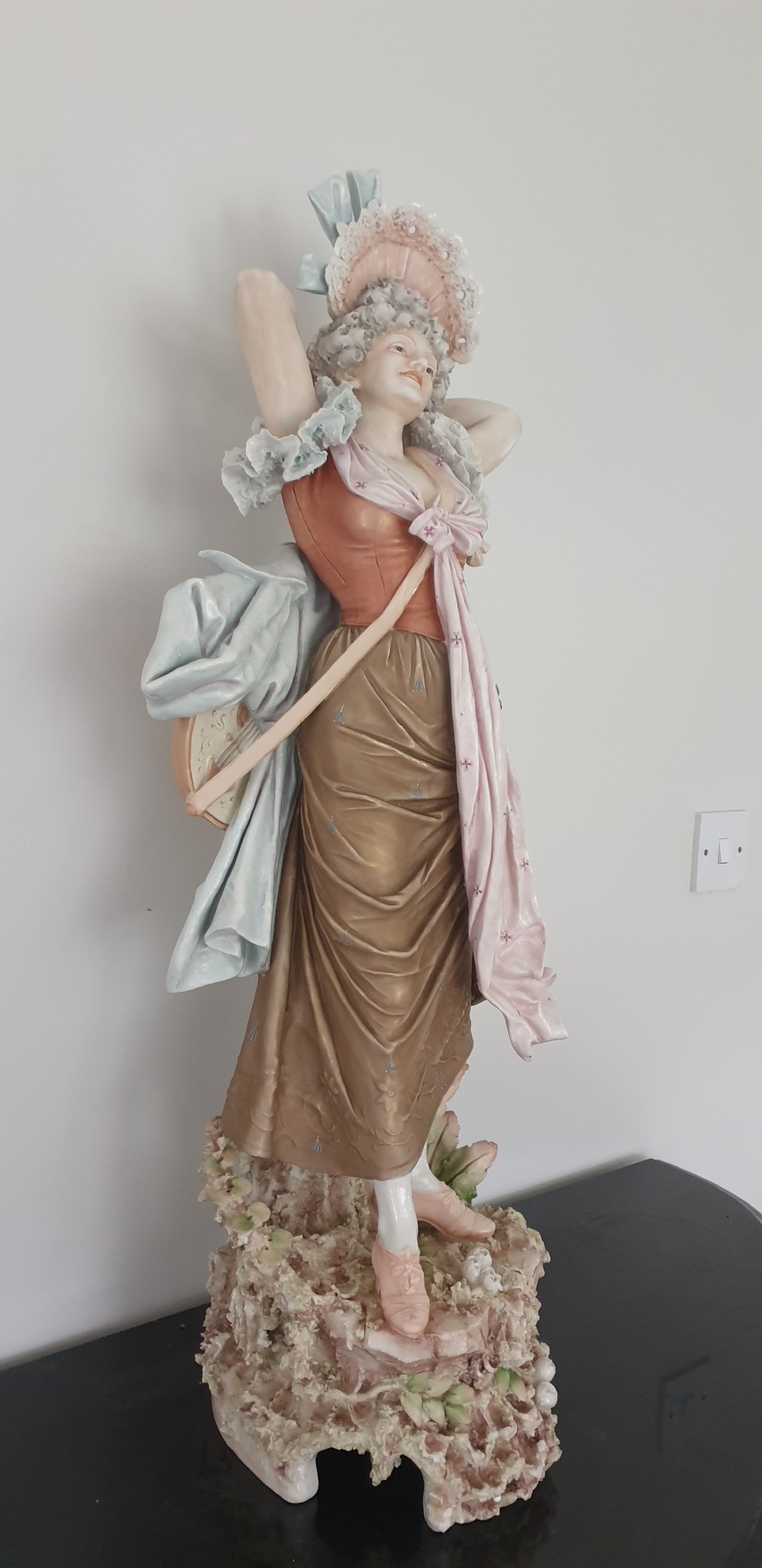 A tall Royal Dux porcelain figure of a lady in historical attire holding a musical instrument on an ornate base. View VII