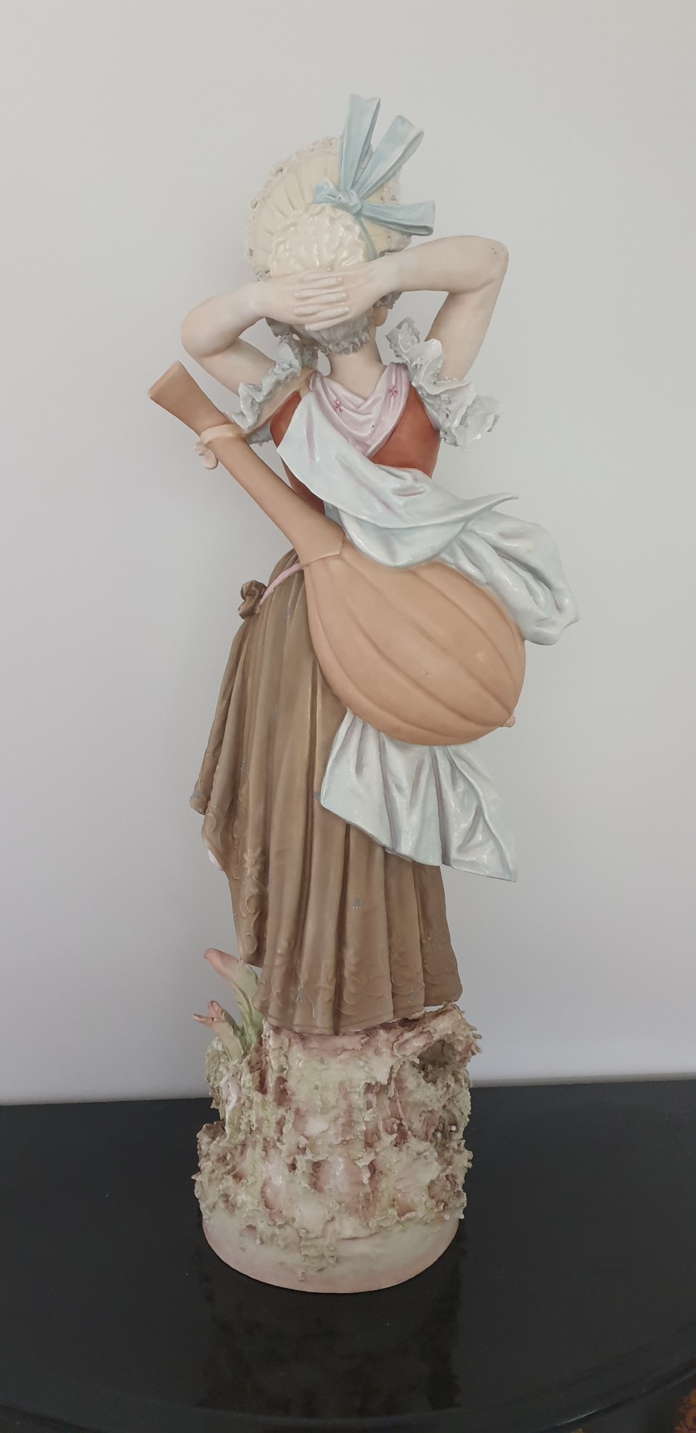 A tall Royal Dux porcelain figure of a lady in historical attire holding a musical instrument on an ornate base. View VIII