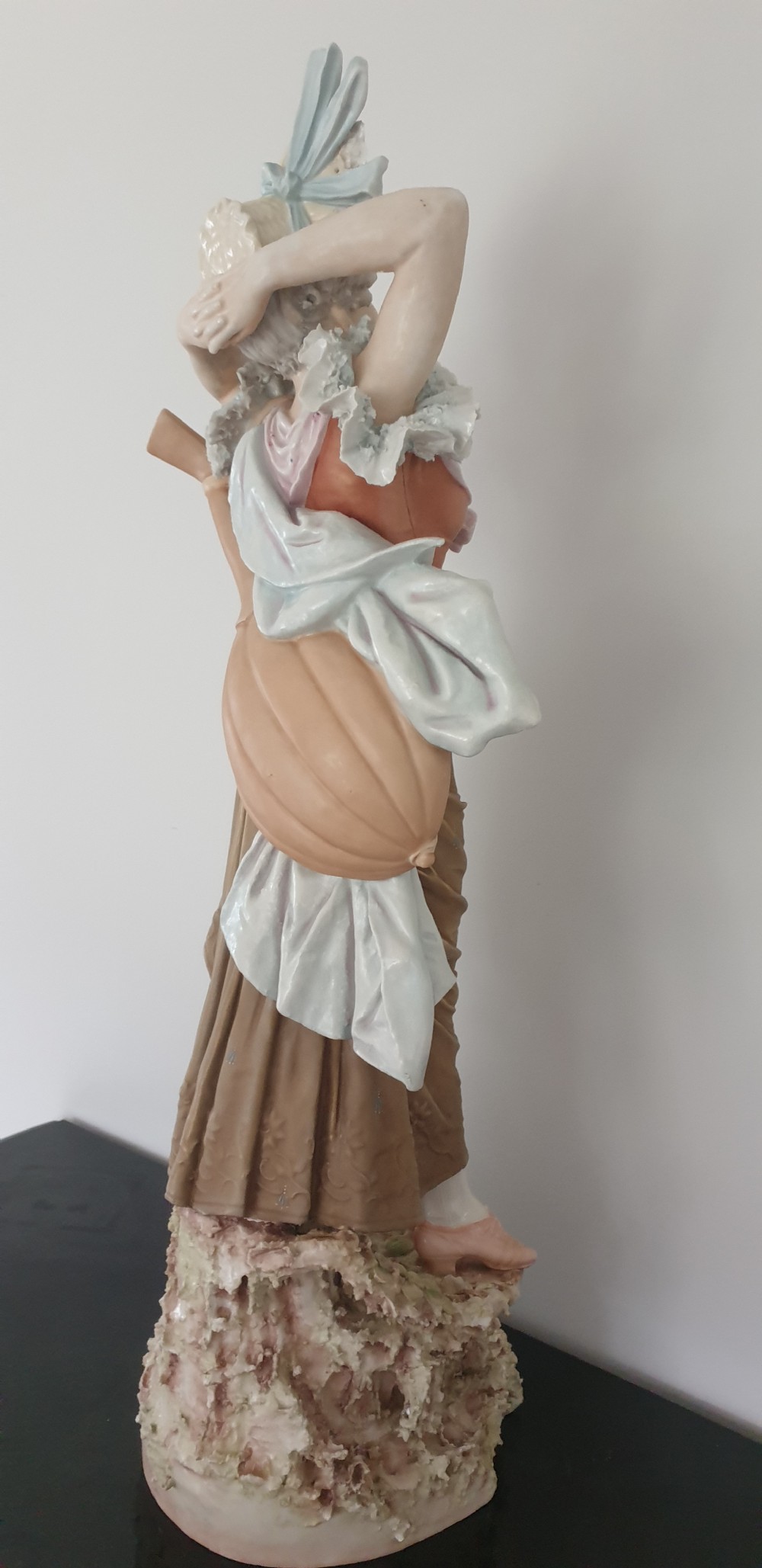 A tall Royal Dux porcelain figure of a lady in historical attire holding a musical instrument on an ornate base. View IX