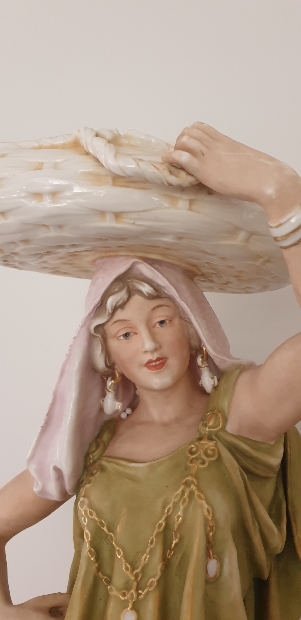 A pair of large antique Royal Dux porcelain figures depicting male and female water carriers in olive green and terracotta attire. View V
