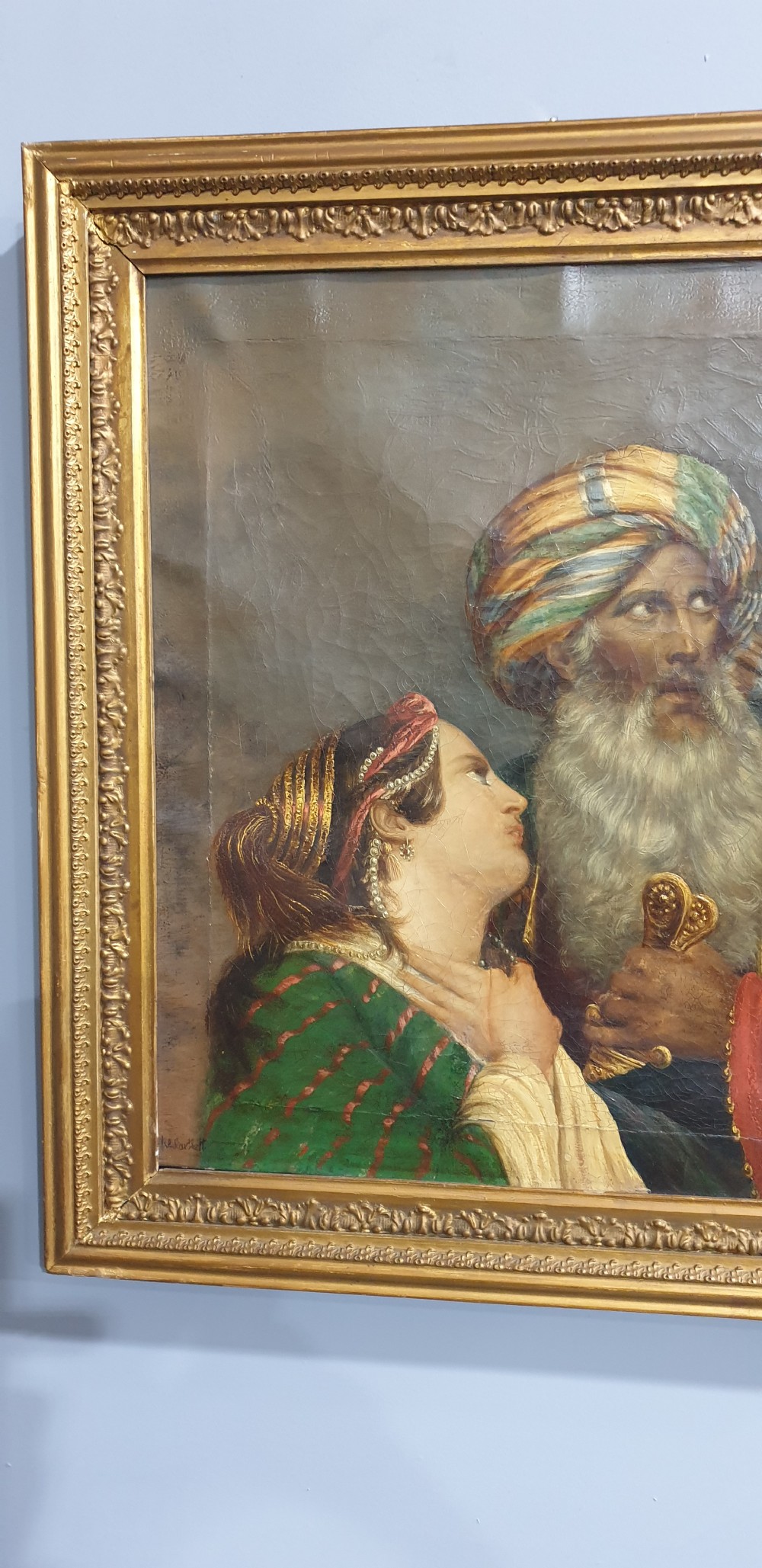 An antique framed oil painting on canvas depicting a bearded man in a turban alongside a woman looking upward. View IV