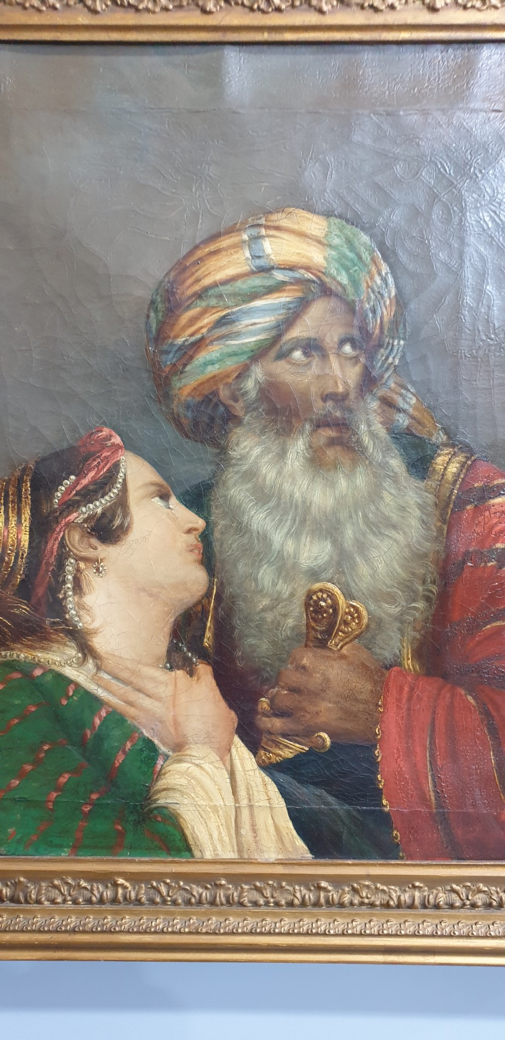 An antique framed oil painting on canvas depicting a bearded man in a turban alongside a woman looking upward. View V