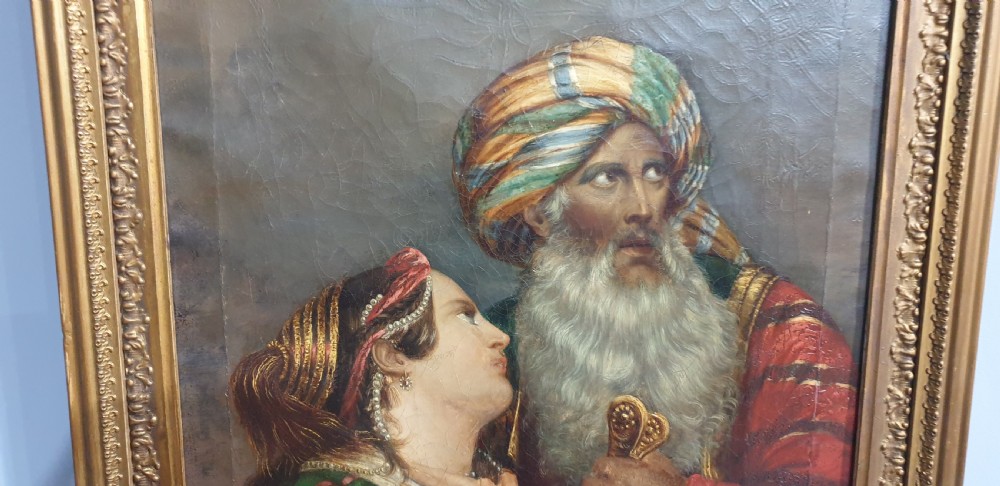 An antique framed oil painting on canvas depicting a bearded man in a turban alongside a woman looking upward. View VI