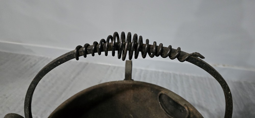 An Arts and Crafts coal bucket featuring a hemispherical brass bowl set within a wrought iron frame with scrolled feet and a spiral wire handle. View III