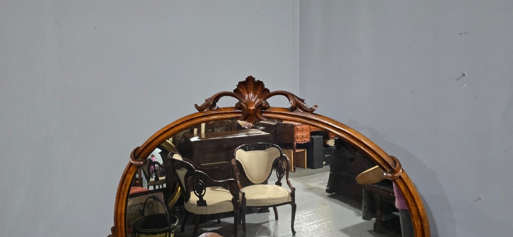 An antique burr walnut side cabinet featuring an arched top mirror with a carved cresting and glass mirrored door panels. View XV