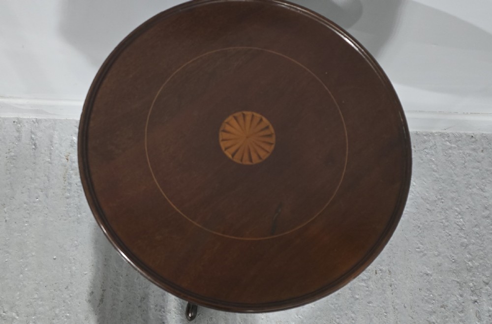 A round mahogany wine table featuring an inlaid central starburst motif, a turned column pedestal, and three splayed legs. View V