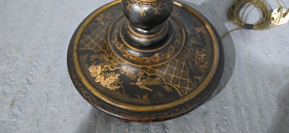 A black lacquered standard floor lamp decorated with gilded hand-painted Chinoiserie foliage and landscapes, topped with a cream fringed lampshade. View VII