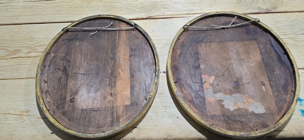 A pair of matching oval wall mirrors featuring molded gold gilt frames and bevelled glass plates. View VIII