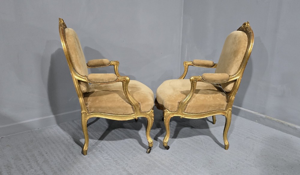 A pair of French giltwood bergere armchairs upholstered in mustard velvet with studded borders and cabriole legs. View VI