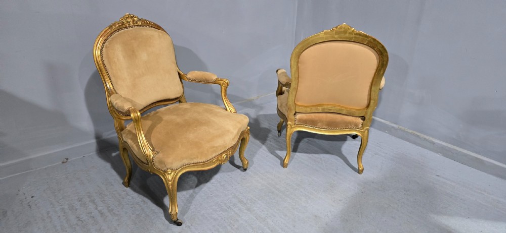 A pair of French giltwood bergere armchairs upholstered in mustard velvet with studded borders and cabriole legs. View VII