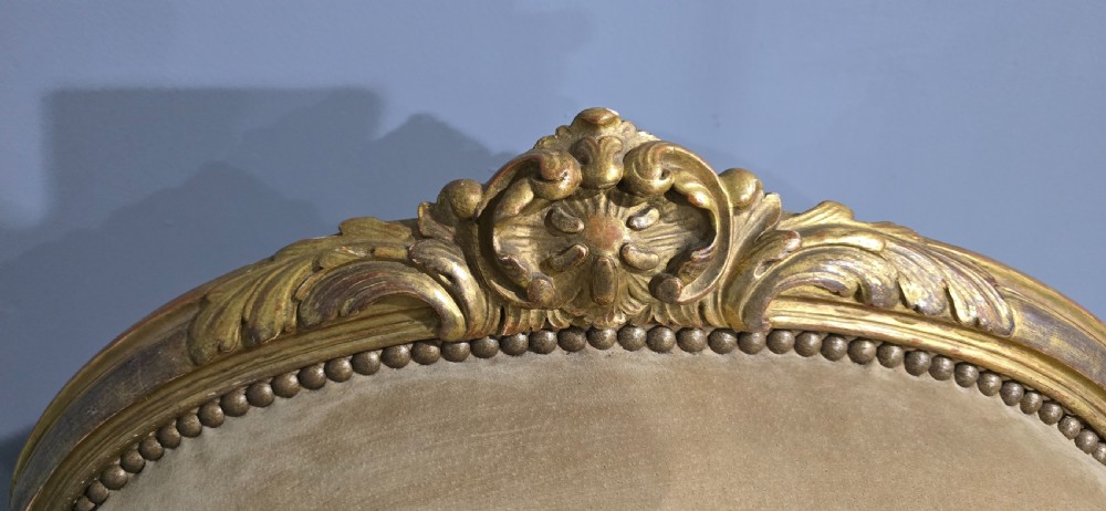 A pair of French giltwood bergere armchairs upholstered in mustard velvet with studded borders and cabriole legs. View VIII