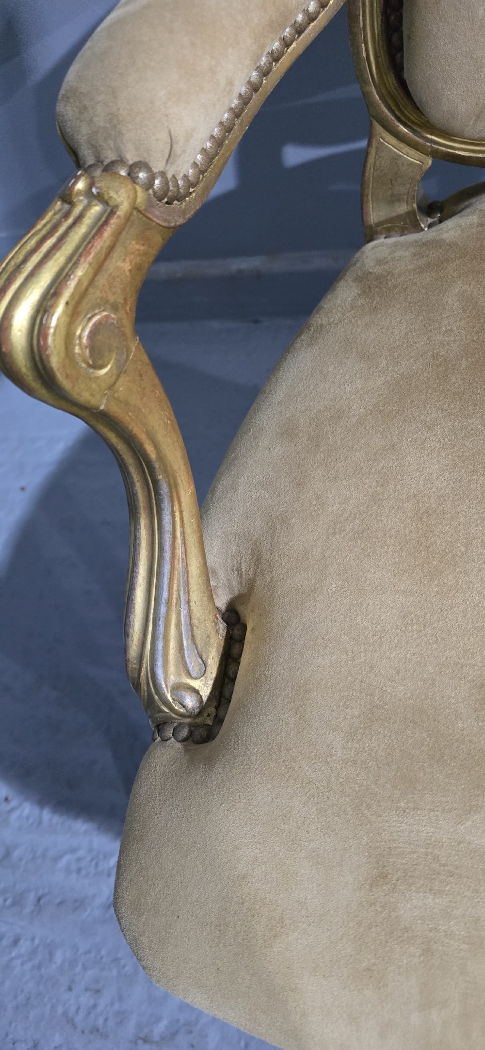 A pair of French giltwood bergere armchairs upholstered in mustard velvet with studded borders and cabriole legs. View IX