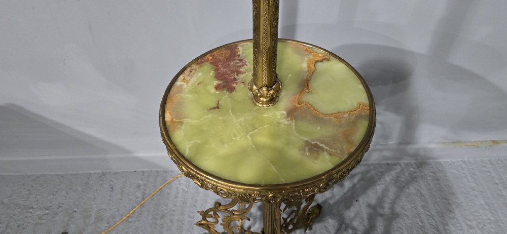 An antique cast brass standard lamp featuring an integrated circular green onyx tray and tripod scroll legs. View VI