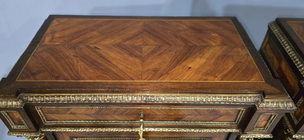 A pair of tall French Louis XVI style wooden side cabinets featuring parquetry veneers, fluted columns, gilt-bronze mounts, and central oval porcelain plaques painted with cherubs. View VII