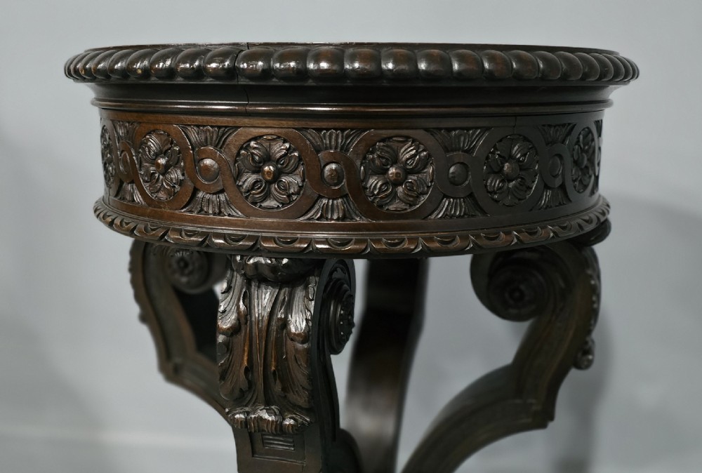 A Victorian dark carved timber side table with a circular black marble top featuring an inlaid floral pietra dura motif. View VIII