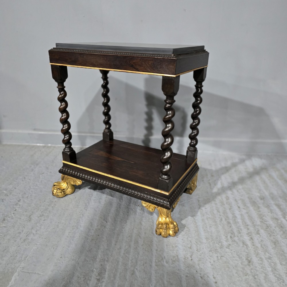 A rectangular dark rosewood two-tier side table featuring spiral turned legs, gilt borders, and carved gilded paw feet. View II