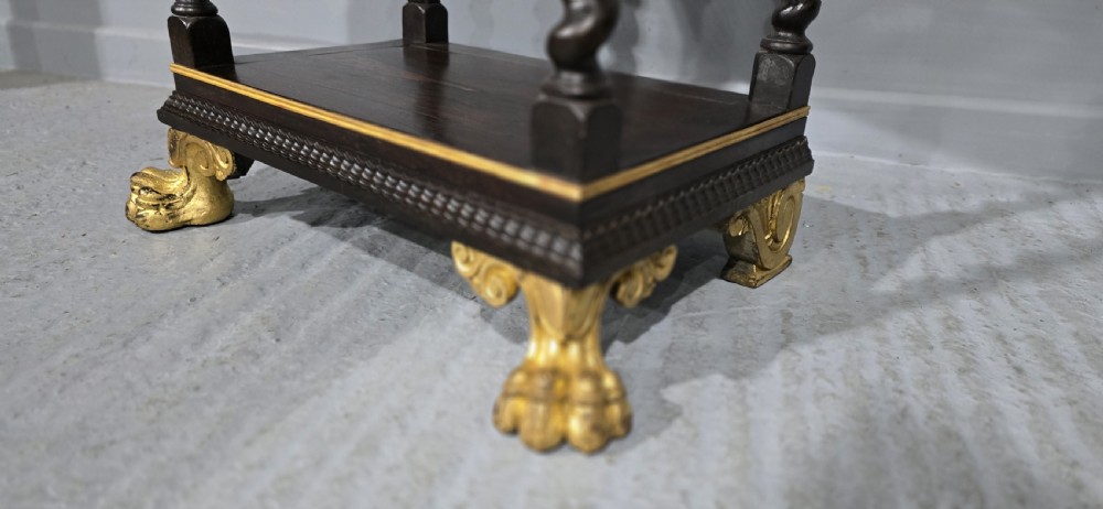A rectangular dark rosewood two-tier side table featuring spiral turned legs, gilt borders, and carved gilded paw feet. View VII