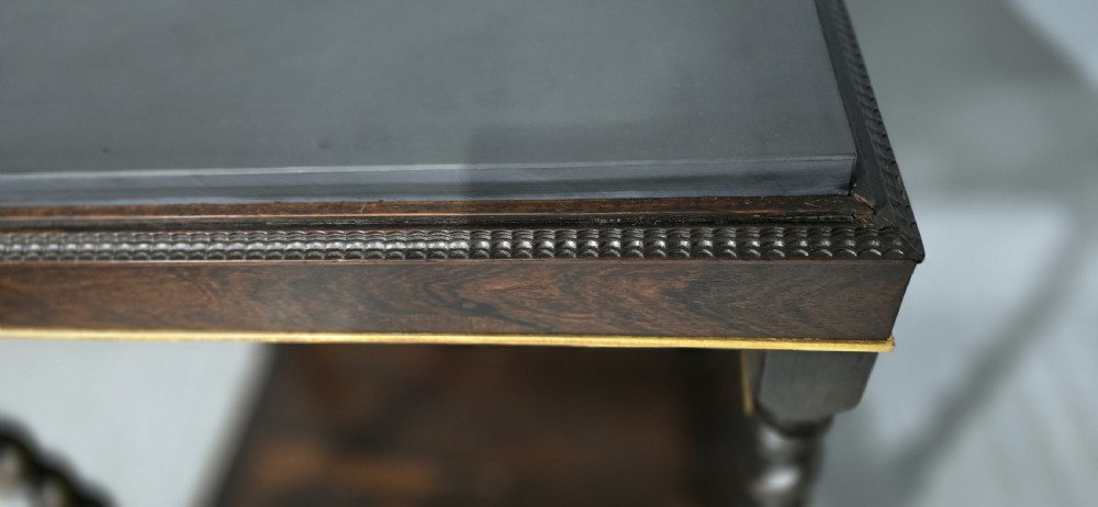A rectangular dark rosewood two-tier side table featuring spiral turned legs, gilt borders, and carved gilded paw feet. View X