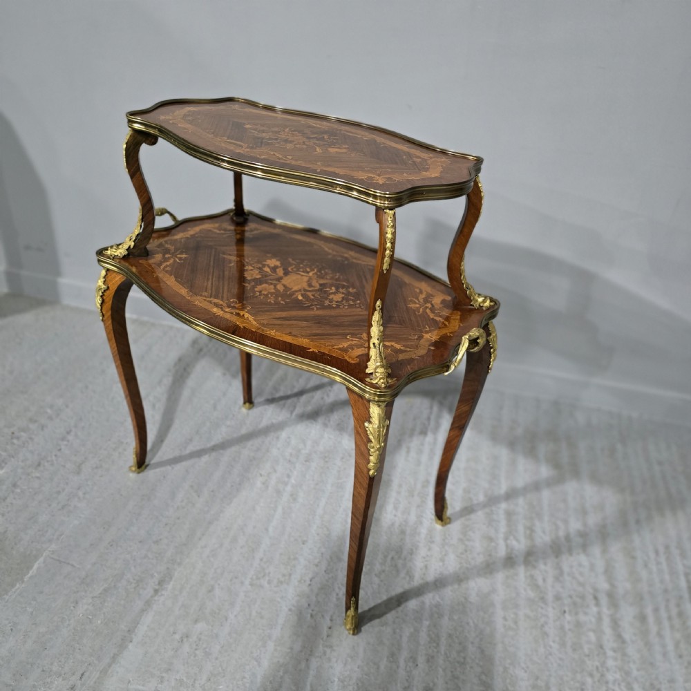 A two-tier French marquetry table featuring floral wood inlay, cabriole legs, and ornate gilt-bronze ormolu mounts. View II