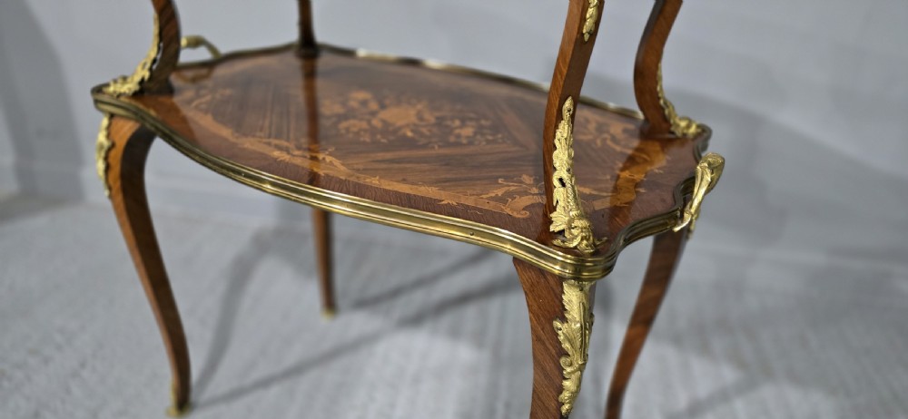 A two-tier French marquetry table featuring floral wood inlay, cabriole legs, and ornate gilt-bronze ormolu mounts. View XI