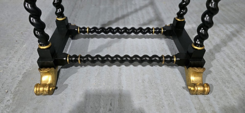 A rectangular ebonised black wood centre table featuring gold parcel gilded accents, spiral barley twist legs, drop finials, and an H-stretcher. View II