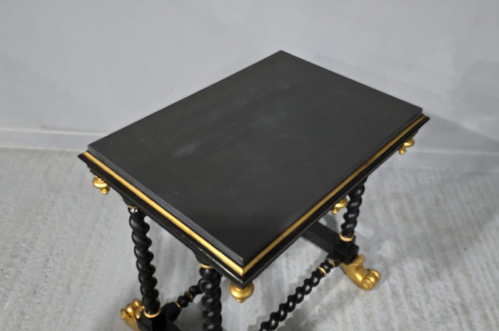 A rectangular ebonised black wood centre table featuring gold parcel gilded accents, spiral barley twist legs, drop finials, and an H-stretcher. View XI