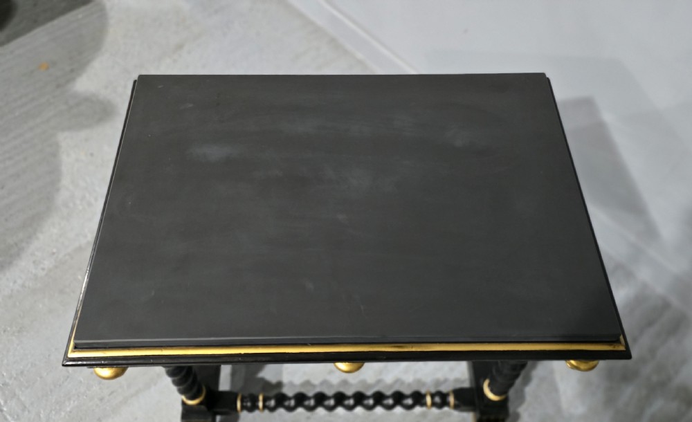 A rectangular ebonised black wood centre table featuring gold parcel gilded accents, spiral barley twist legs, drop finials, and an H-stretcher. View XII