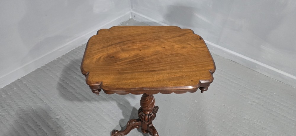 A Victorian mahogany pedestal table featuring a scalloped rim with turned pendant drops, a spiral carved central column, and tripod cabriole legs. View VI