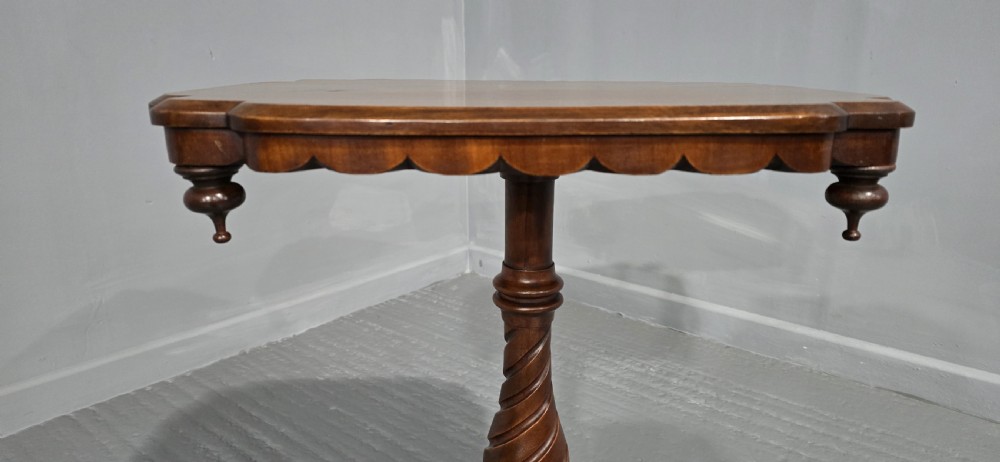 A Victorian mahogany pedestal table featuring a scalloped rim with turned pendant drops, a spiral carved central column, and tripod cabriole legs. View VII