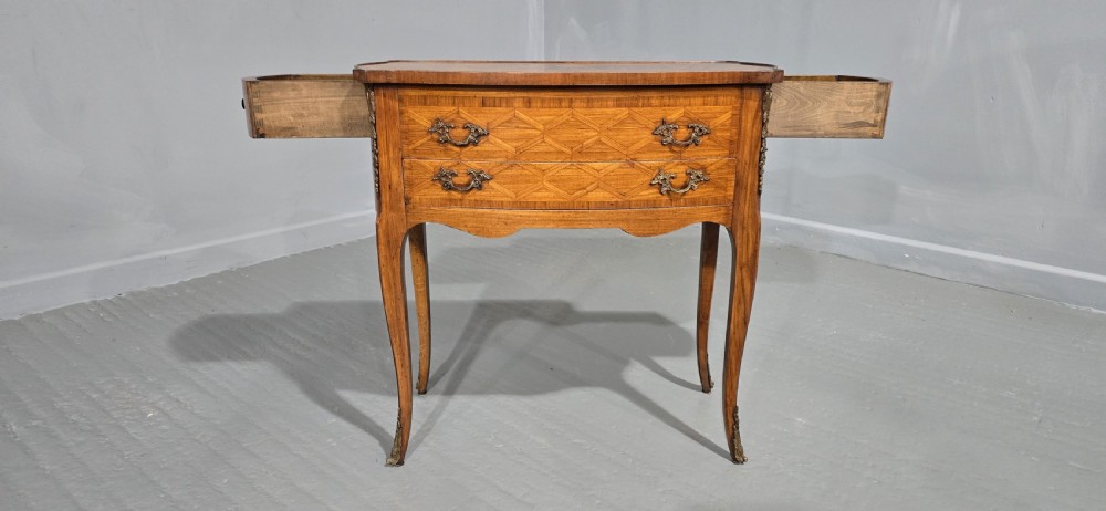 A French Louis XV style marquetry side table with a serpentine top, floral wood inlays, two drawers with brass handles, and slender cabriole legs. View V