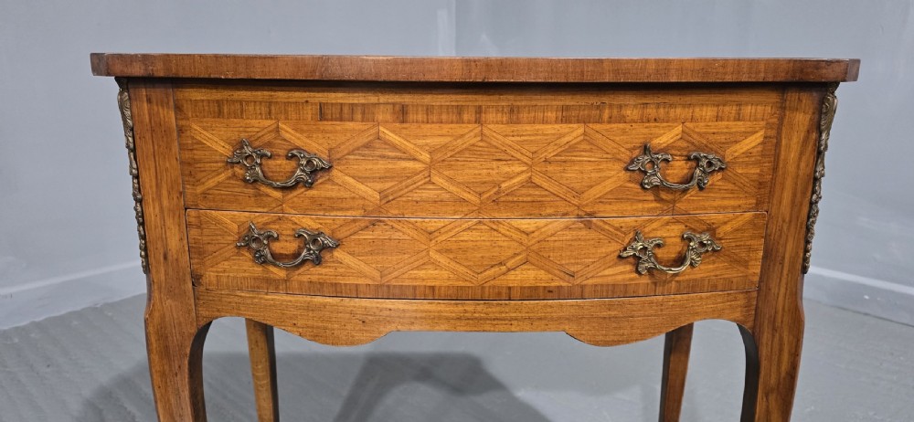 A French Louis XV style marquetry side table with a serpentine top, floral wood inlays, two drawers with brass handles, and slender cabriole legs. View VIII