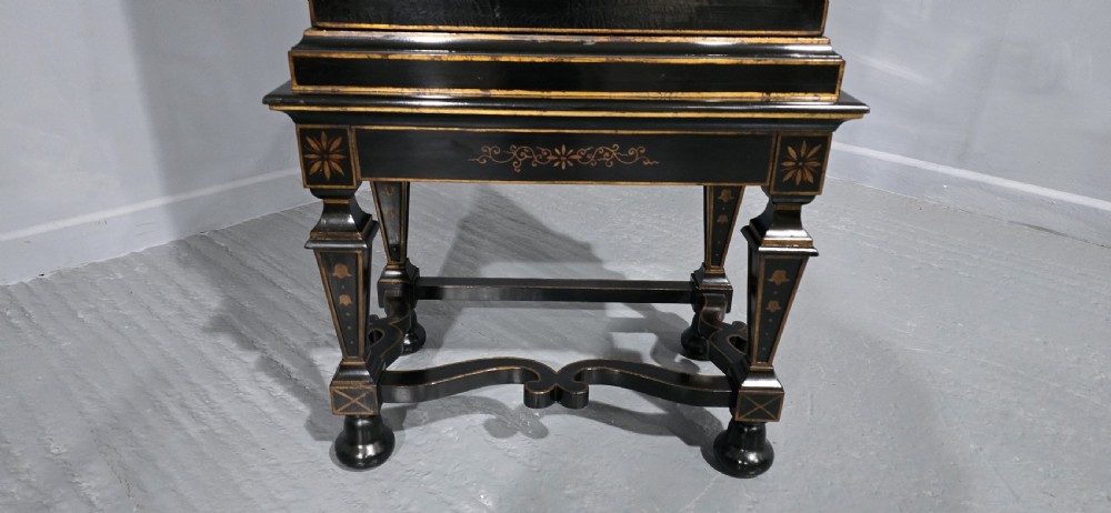 A tall black lacquered cabinet on stand featuring hand-painted floral urn artwork on the front door and curved stretchered legs. View IV