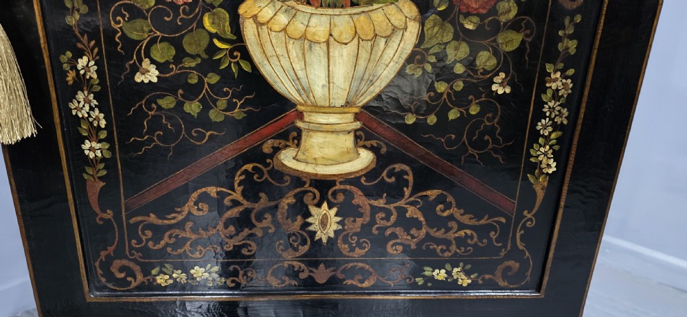A tall black lacquered cabinet on stand featuring hand-painted floral urn artwork on the front door and curved stretchered legs. View XVI