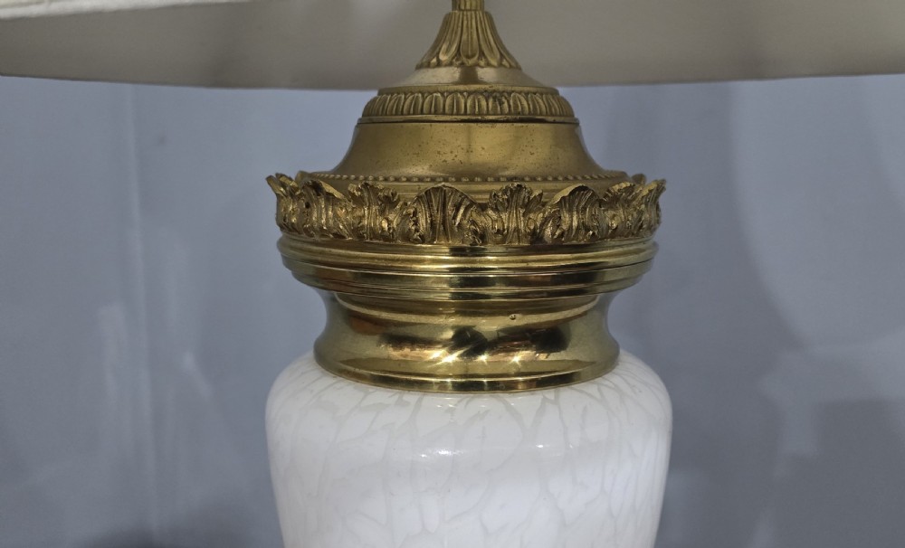 An antique French table lamp with an urn-shaped white opaline glass body, chased gilt bronze ormolu mounts, and a cream flared fabric shade. View III