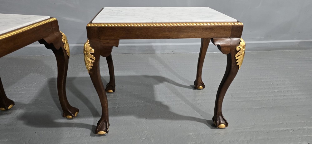 A pair of rectangular dark mahogany lamp tables featuring white marble inset tops, gilded acanthus leaf carvings, and carved cabriole legs with ball and claw feet. View VI