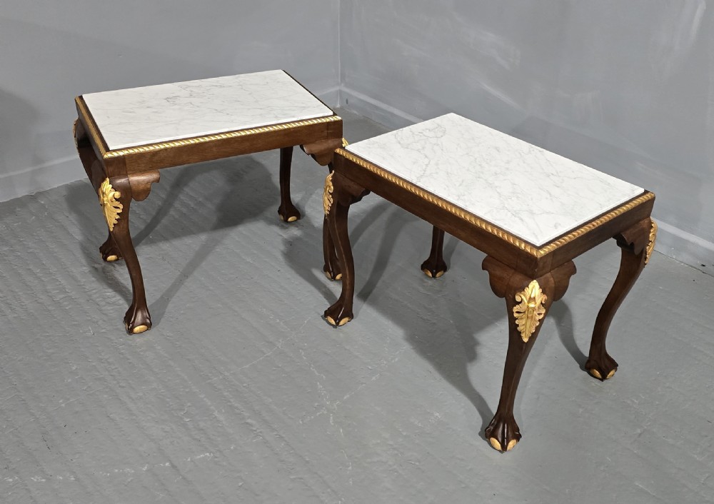 A pair of rectangular dark mahogany lamp tables featuring white marble inset tops, gilded acanthus leaf carvings, and carved cabriole legs with ball and claw feet. View X