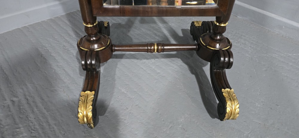 A Regency mahogany cheval mirror featuring a rectangular tilting glass frame supported by turned upright posts and splayed legs with gilded leaf ornamentation. View III