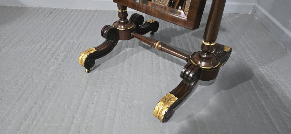 A Regency mahogany cheval mirror featuring a rectangular tilting glass frame supported by turned upright posts and splayed legs with gilded leaf ornamentation. View IV