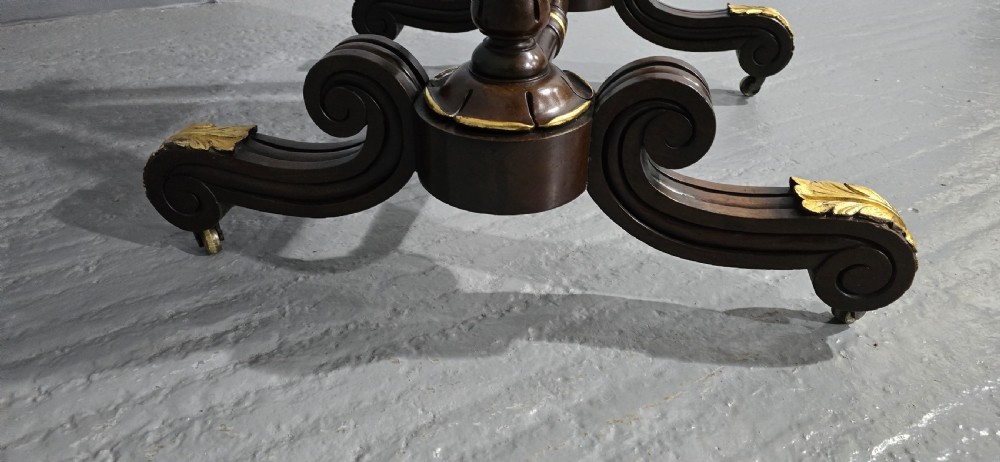 A Regency mahogany cheval mirror featuring a rectangular tilting glass frame supported by turned upright posts and splayed legs with gilded leaf ornamentation. View VIII