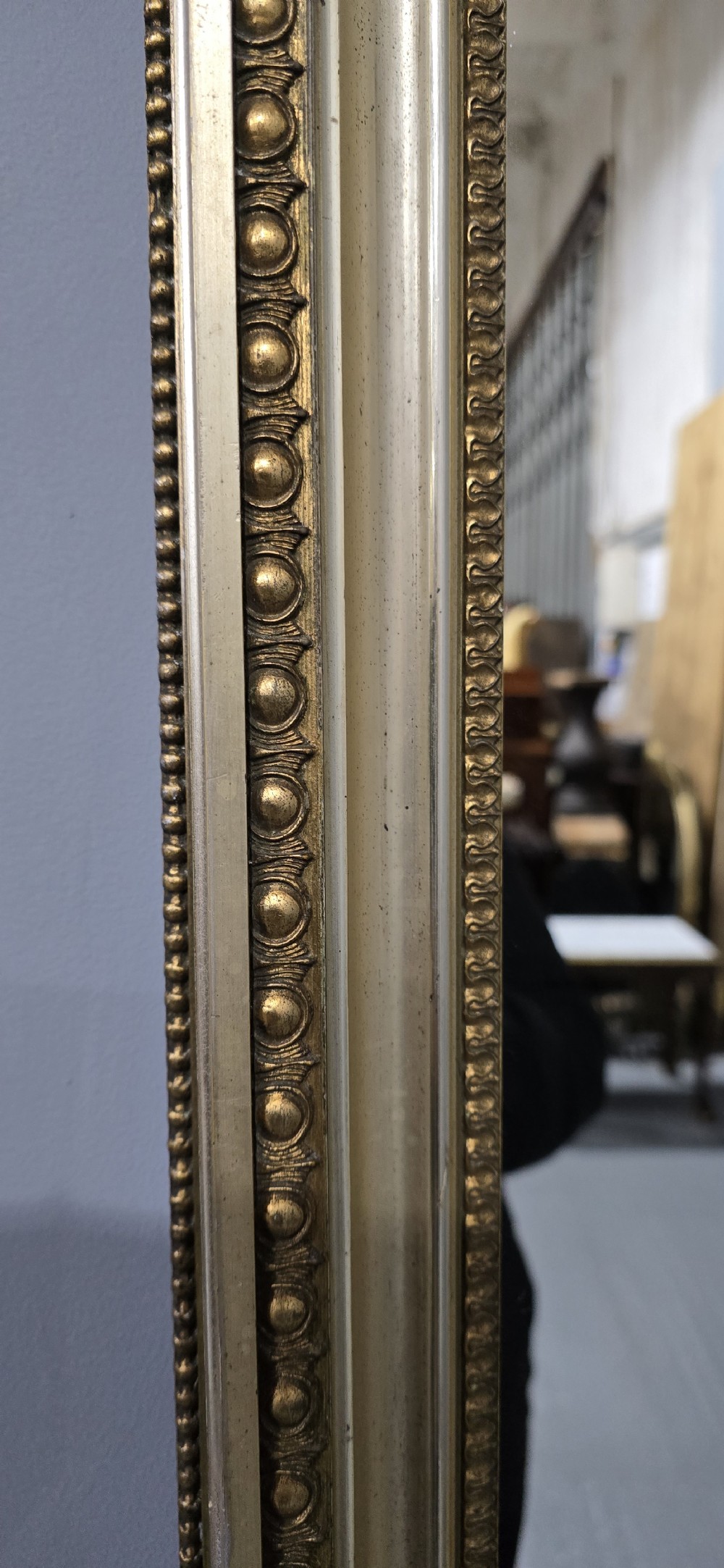 A matching pair of rectangular Victorian giltwood wall mirrors featuring beaded inner and outer frame details. View VII