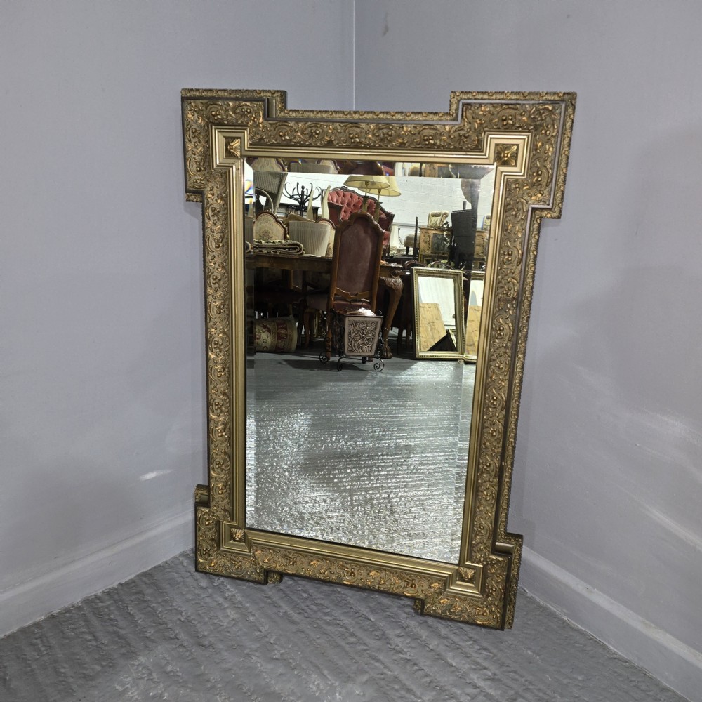 A large rectangular French giltwood wall mirror featuring elaborate carved corner mouldings and bevelled glass. View II