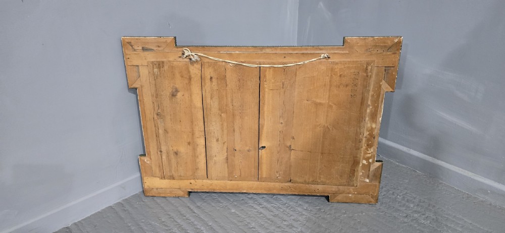 A large rectangular French giltwood wall mirror featuring elaborate carved corner mouldings and bevelled glass. View XI