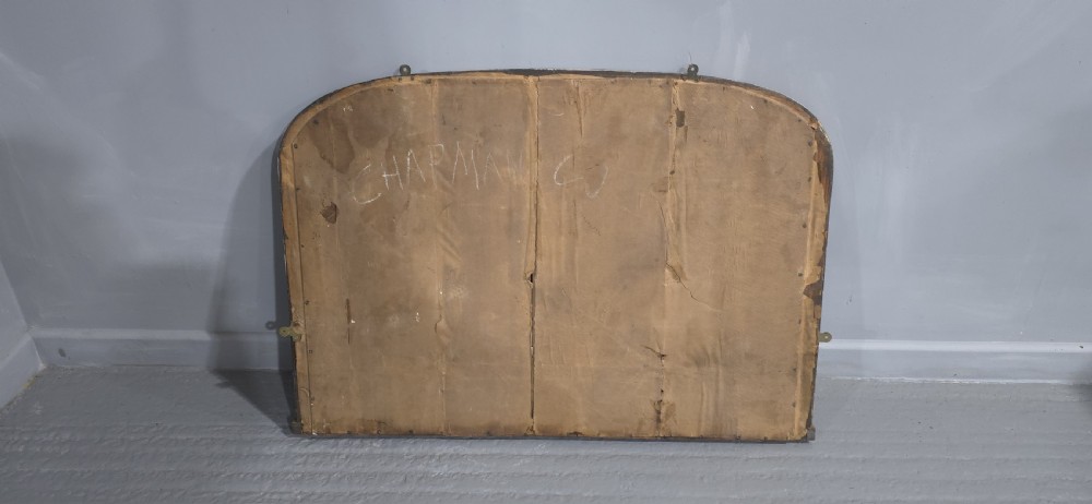 A Victorian arched overmantel mirror with a cream painted wooden frame detailed with floral relief moulding. View IX