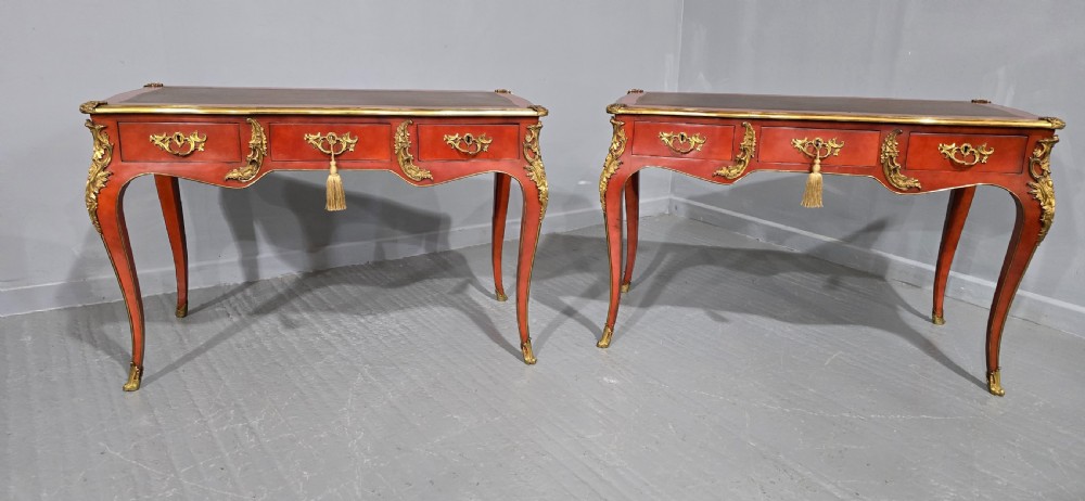 A pair of red lacquered French bureau plat writing desks featuring inset leather tops, three frieze drawers, and gilt bronze mounts on cabriole legs. View II